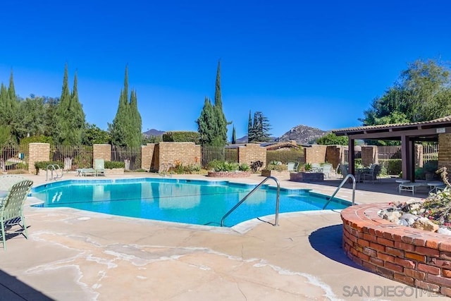 view of pool with a patio and a mountain view