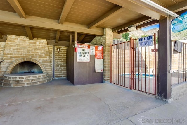 view of patio featuring an outdoor brick fireplace