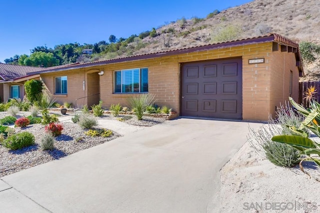 ranch-style house featuring a garage