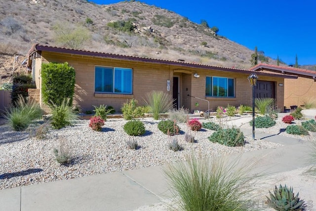 view of front of home with a mountain view and a garage