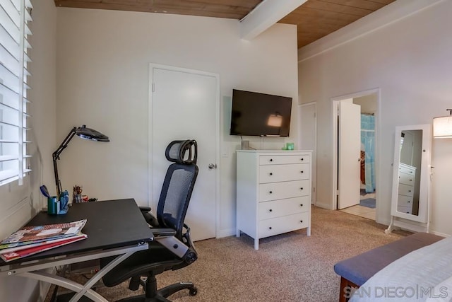 carpeted office space featuring wooden ceiling and vaulted ceiling with beams