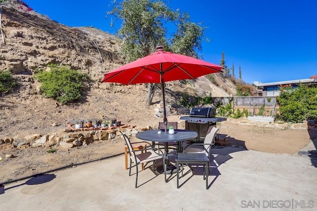 view of patio / terrace featuring grilling area and a mountain view