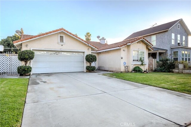 view of front of home with a front yard and a garage