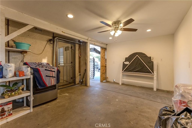 miscellaneous room featuring ceiling fan and concrete floors