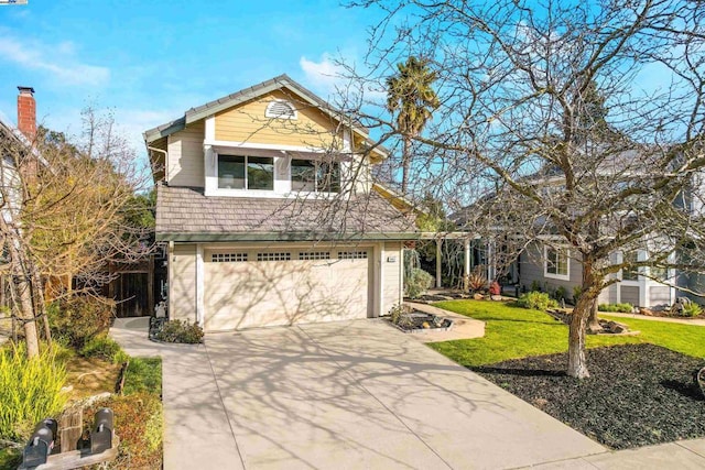 view of front of property with a front yard and a garage