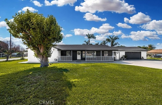 ranch-style home featuring a front yard, covered porch, and a garage