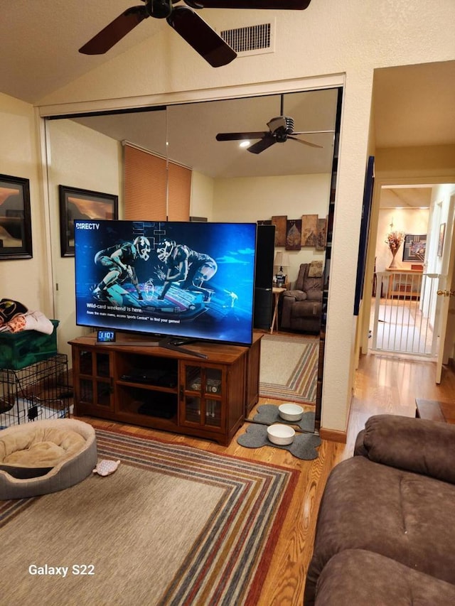 living room with lofted ceiling and hardwood / wood-style floors