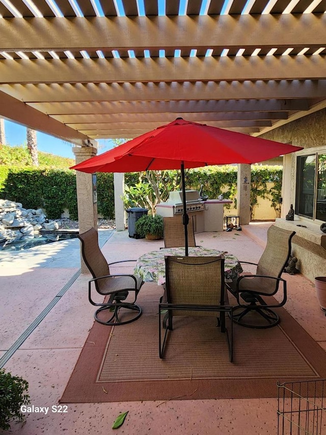 view of patio / terrace featuring area for grilling and a pergola