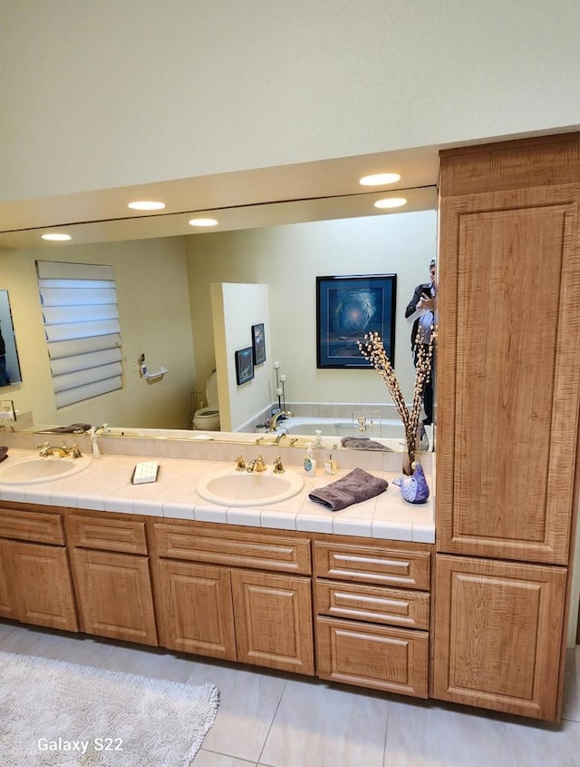 bathroom featuring tile patterned flooring, vanity, and toilet