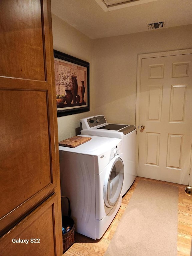 washroom with washing machine and clothes dryer