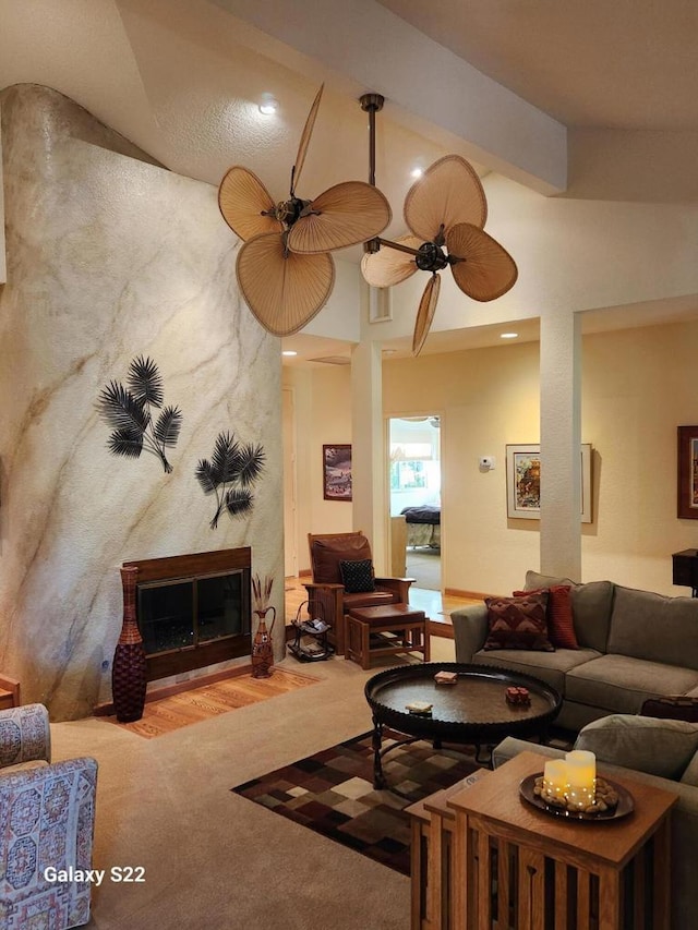 carpeted living room featuring ceiling fan and vaulted ceiling