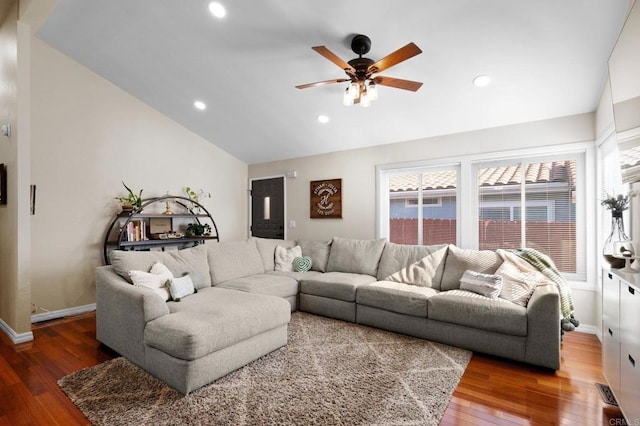 living room with lofted ceiling, dark hardwood / wood-style flooring, and ceiling fan