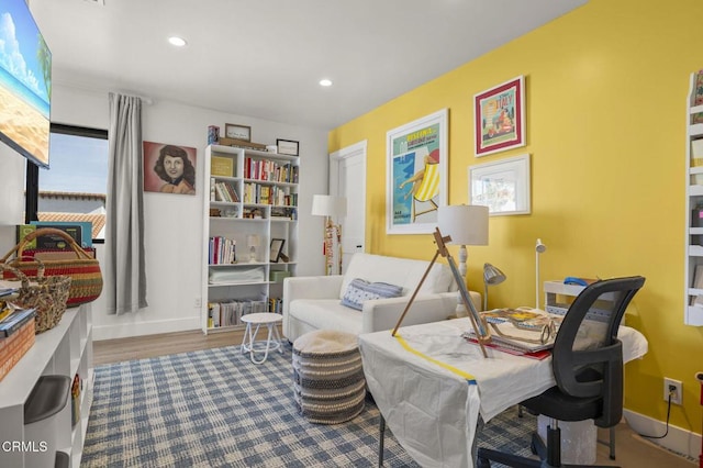 sitting room with wood-type flooring and a healthy amount of sunlight