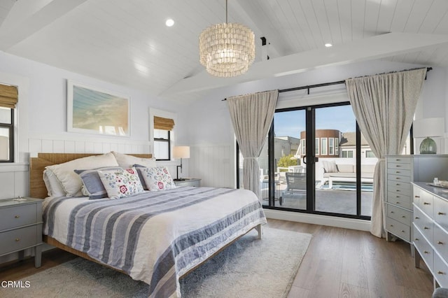 bedroom featuring hardwood / wood-style flooring, a chandelier, lofted ceiling with beams, and access to outside