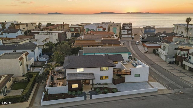 aerial view at dusk with a water view