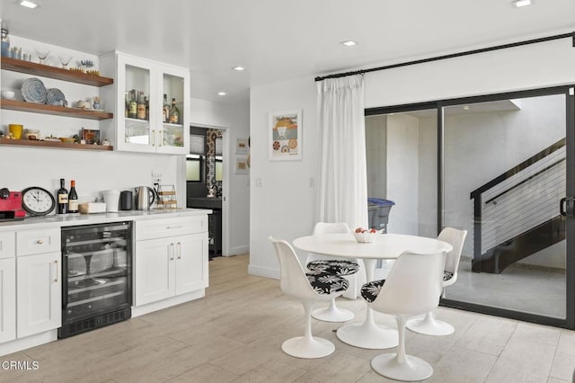 interior space featuring white cabinetry, beverage cooler, and light wood-type flooring