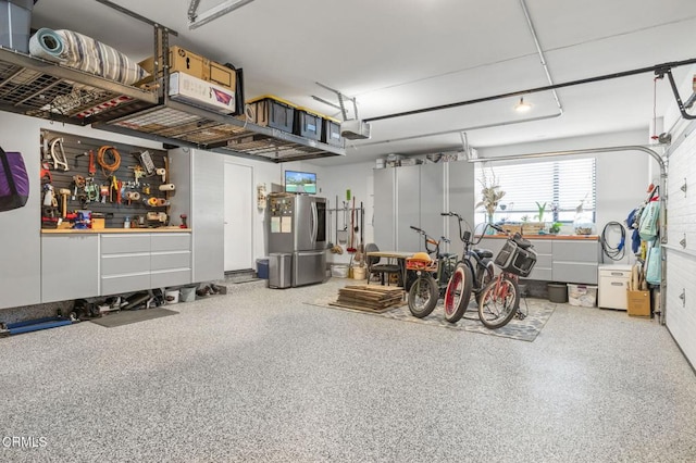 garage featuring a garage door opener and stainless steel fridge