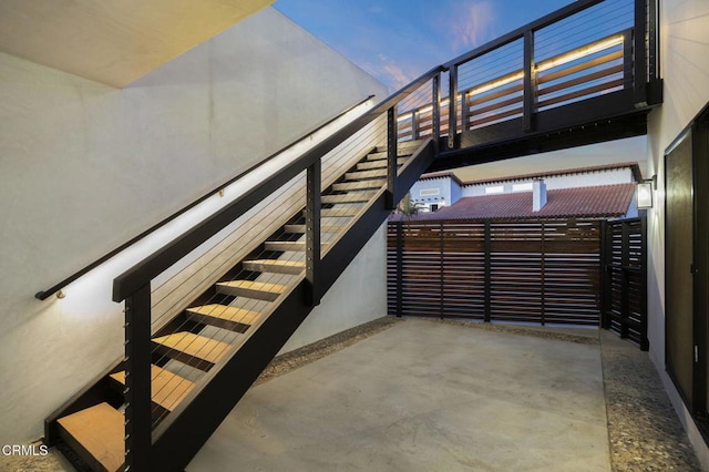 staircase with concrete floors