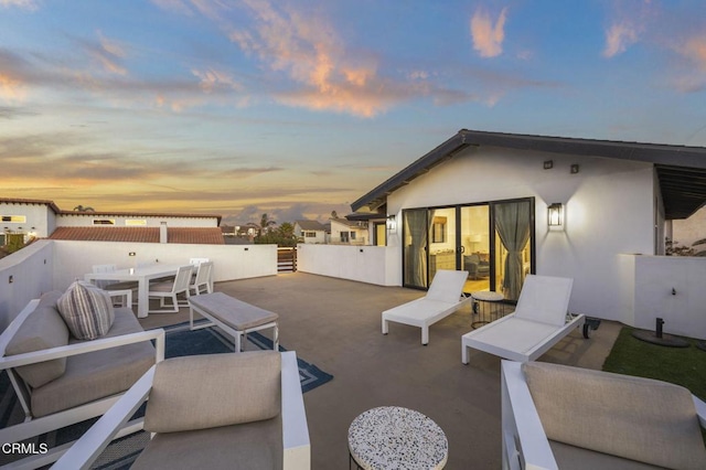 view of patio terrace at dusk