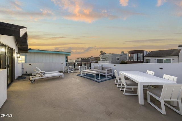 patio terrace at dusk featuring an outdoor hangout area