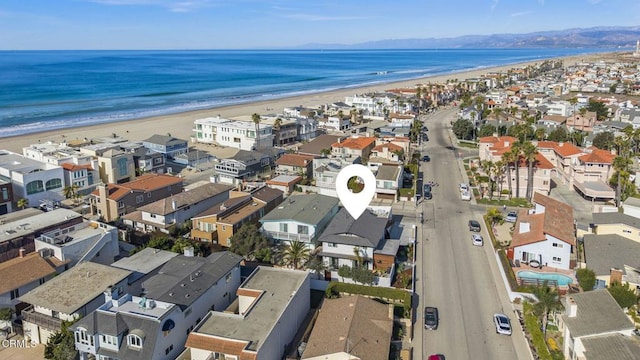 birds eye view of property with a water view and a view of the beach