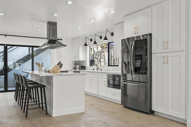 kitchen featuring white cabinetry, a center island, stainless steel refrigerator with ice dispenser, island range hood, and oven