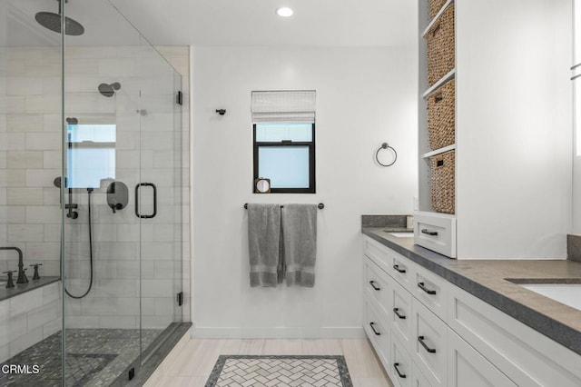 bathroom featuring vanity and a shower with shower door