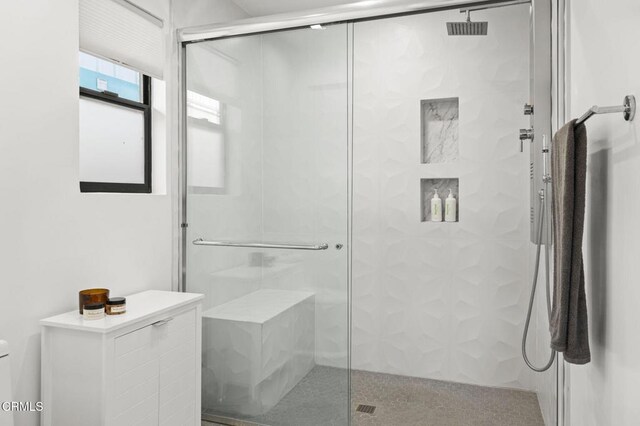 bathroom with walk in shower and toilet