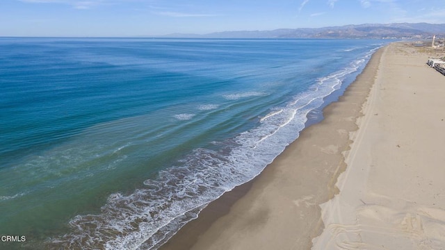 view of water feature featuring a mountain view and a beach view