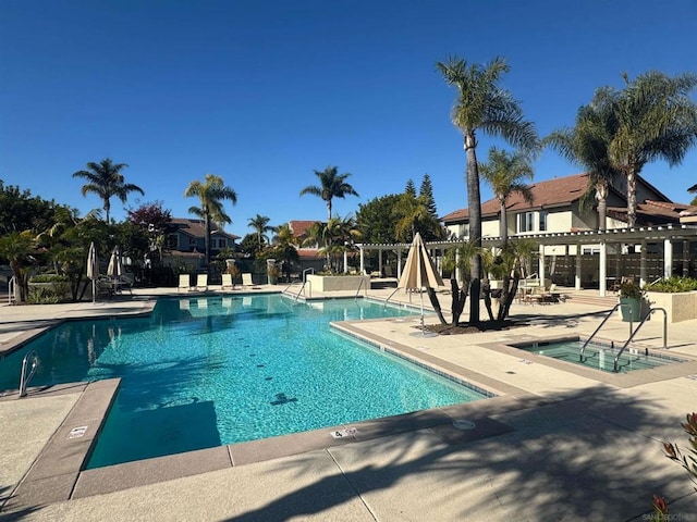 view of swimming pool with a patio and a pergola