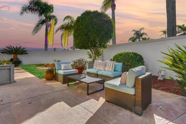 patio terrace at dusk featuring an outdoor hangout area