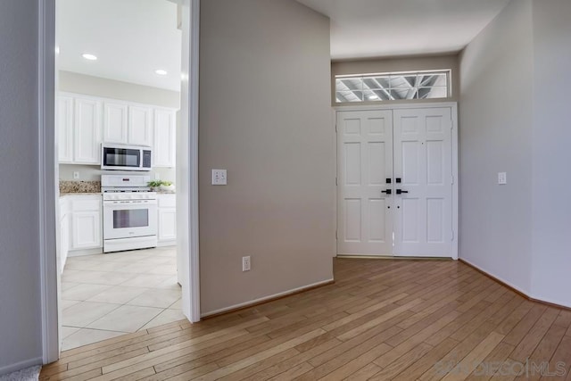 foyer with light hardwood / wood-style floors