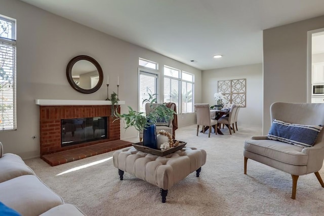 carpeted living room featuring a brick fireplace