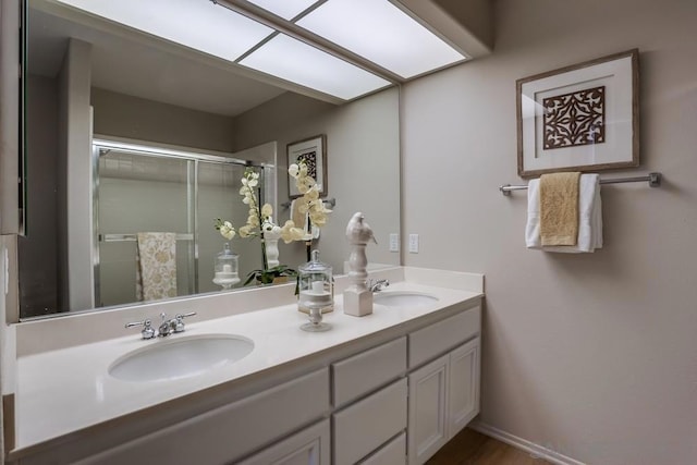 bathroom featuring walk in shower and vanity