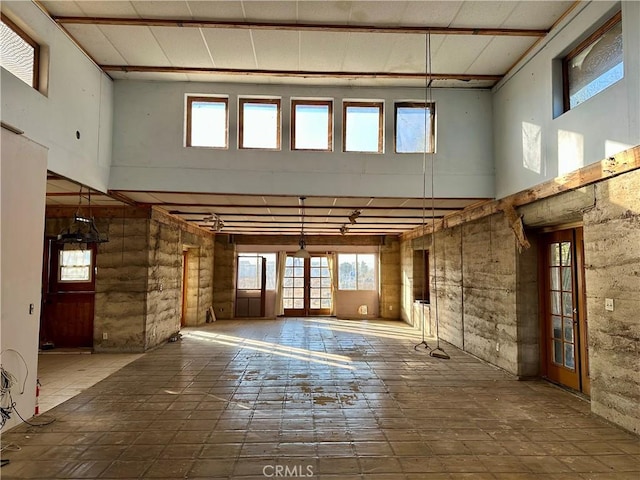 misc room with a towering ceiling and french doors