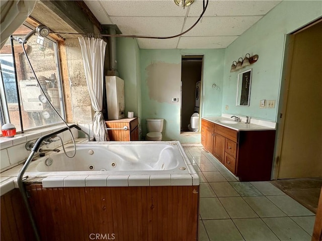 bathroom featuring toilet, a wealth of natural light, a paneled ceiling, and vanity