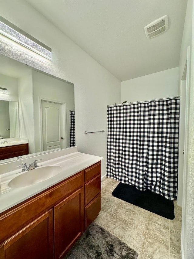 bathroom featuring tile patterned flooring and vanity