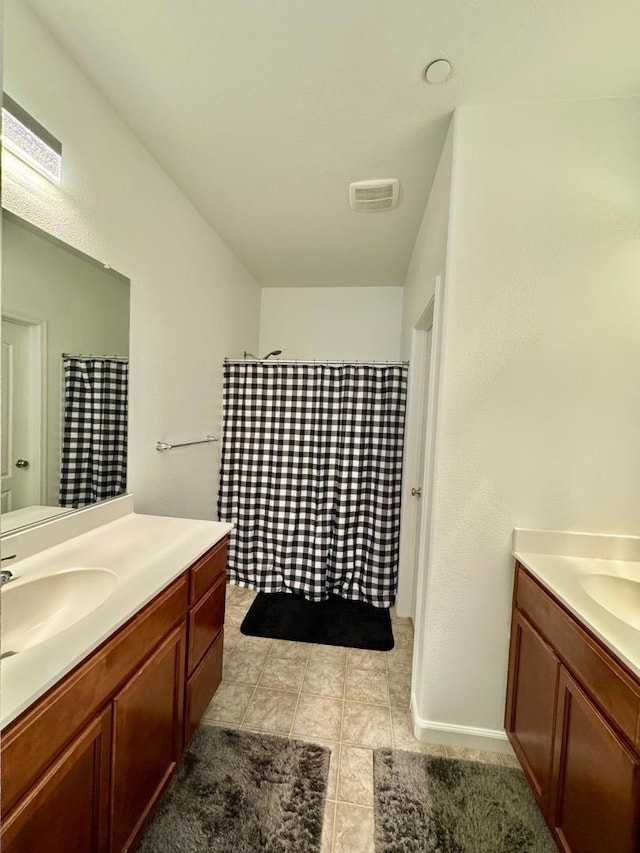 bathroom with tile patterned flooring, curtained shower, and vanity