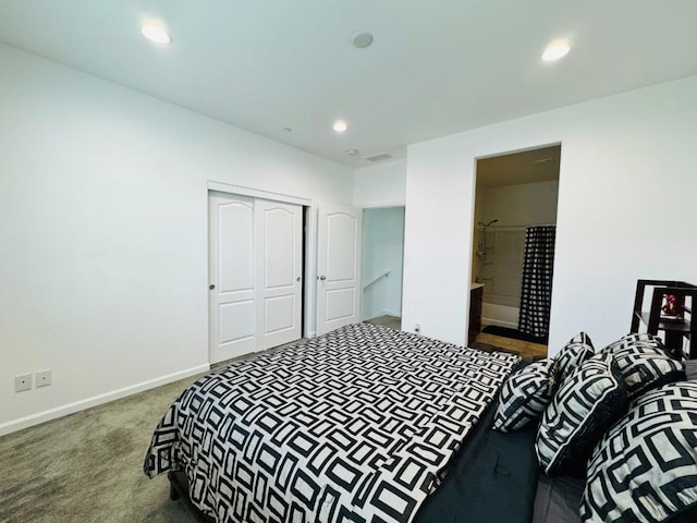 carpeted bedroom with ensuite bath and a closet