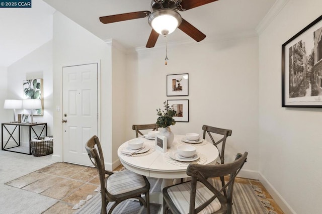 dining space with ornamental molding and ceiling fan