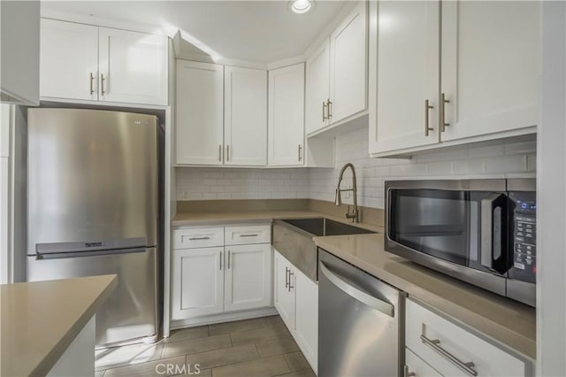 kitchen featuring sink, white cabinets, and appliances with stainless steel finishes