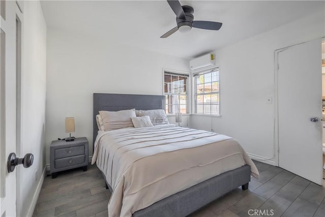 bedroom featuring ceiling fan and a wall mounted AC