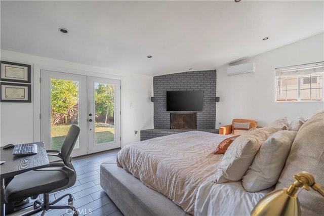 bedroom featuring an AC wall unit, vaulted ceiling, french doors, a brick fireplace, and access to exterior