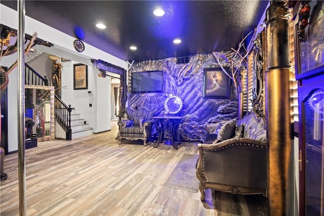 rec room featuring a textured ceiling and hardwood / wood-style floors