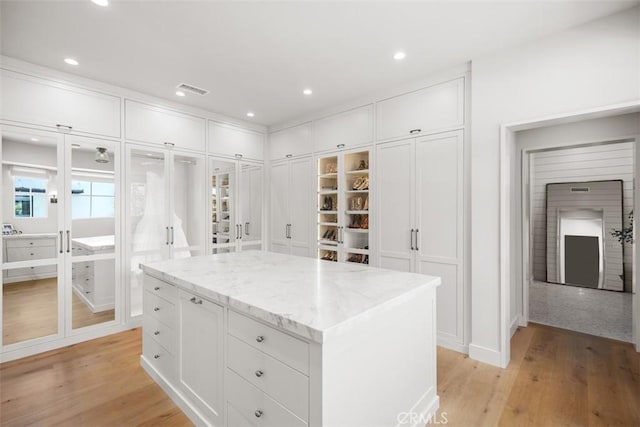 spacious closet with light hardwood / wood-style floors