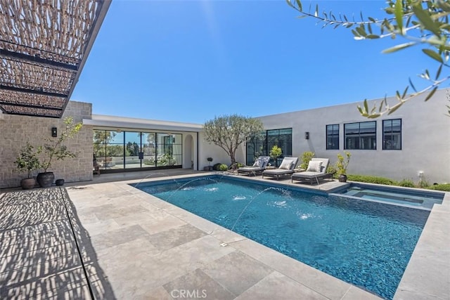 view of swimming pool with pool water feature, a patio area, and an in ground hot tub