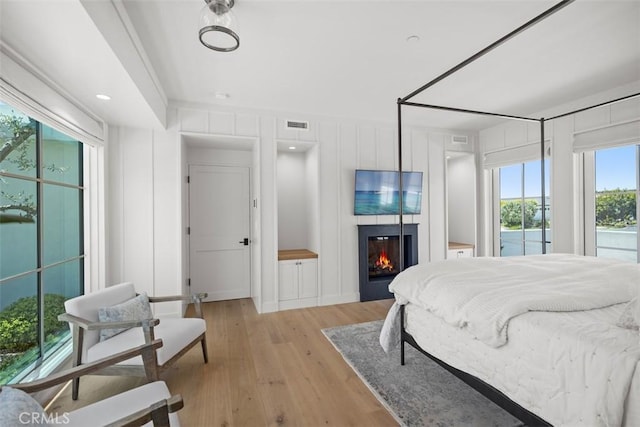 bedroom featuring light wood-type flooring and multiple windows