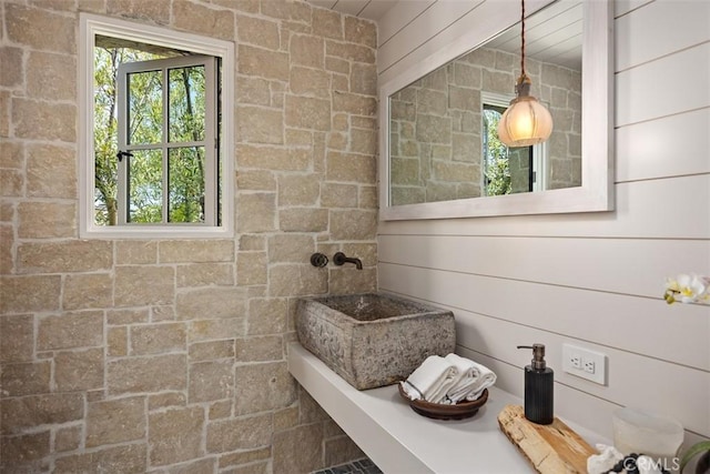 bathroom featuring wooden walls