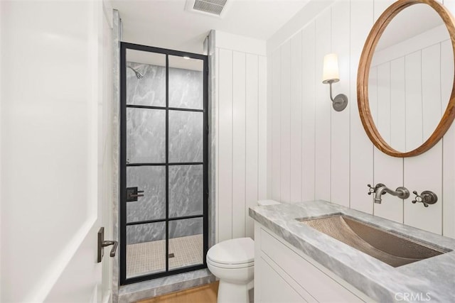 bathroom featuring toilet, wood-type flooring, and vanity