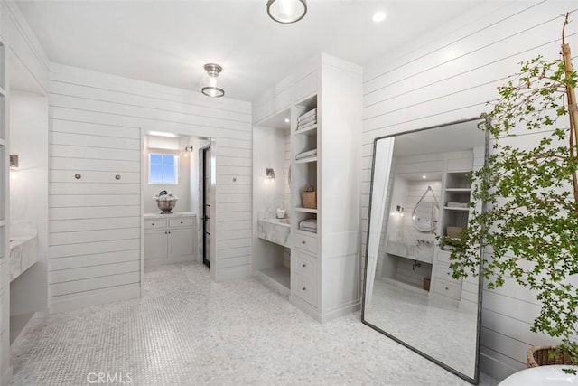 bathroom featuring wooden walls